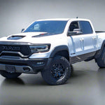 White Ram truck parked in a lot with trees and buildings in the background