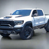 White Ram truck parked in a lot with trees and buildings in the background
