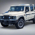 Beige SUV with large wheels on a paved surface.